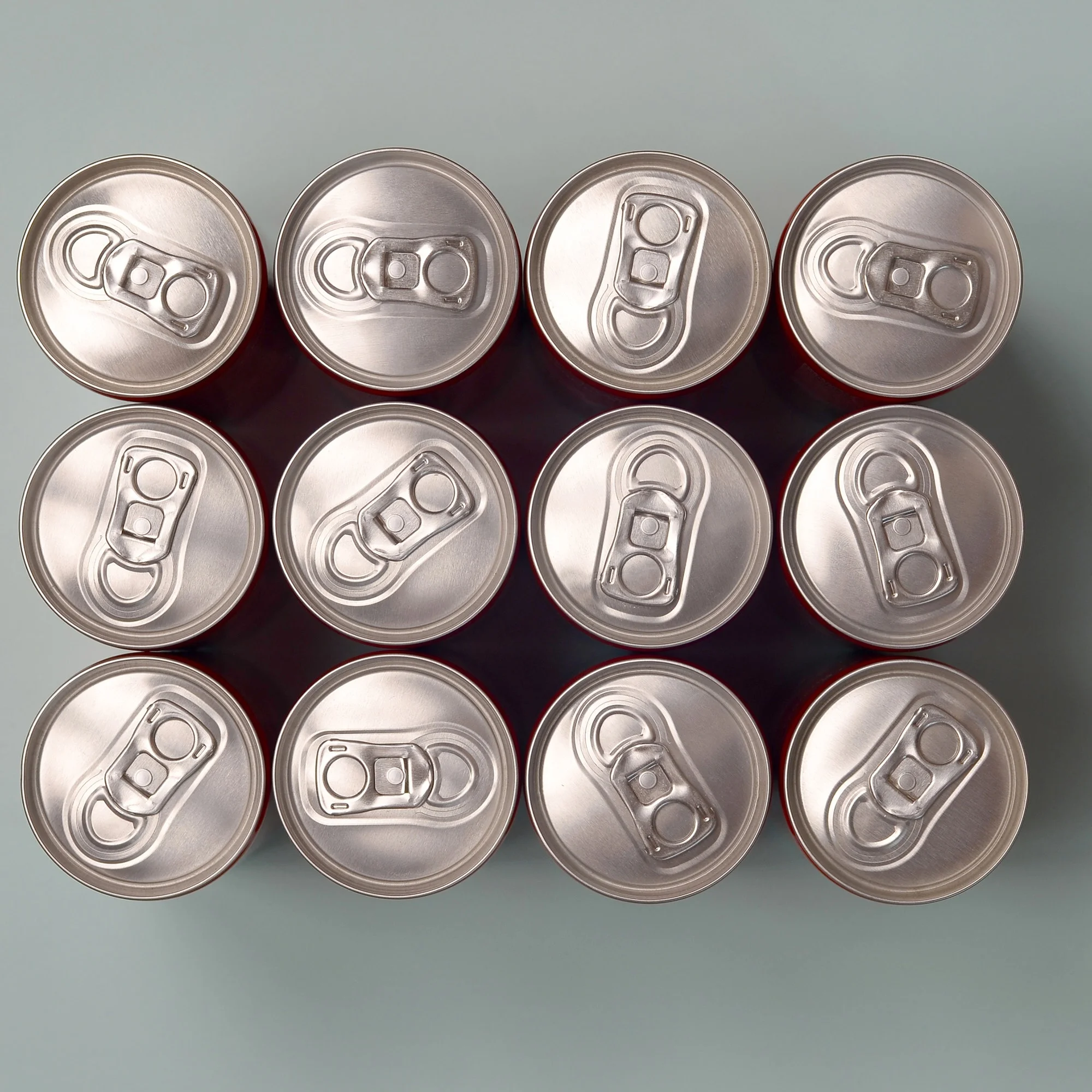 Many new aluminium cans of soda soft drink, lemonade cola, beer or energy drink containers